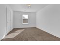 A bright bedroom with plush carpeting and a large window for natural light at 76 Auburn Run Ln, Auburn, GA 30011