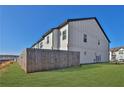 Rear exterior view of a townhome with privacy fence and well-kept lawn at 76 Auburn Run Ln, Auburn, GA 30011