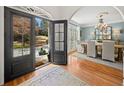 Welcoming foyer with hardwood floors and a view into the formal dining area at 302 W Country Dr, Johns Creek, GA 30097