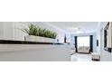 Bright living room showcases hardwood floors, a white sofa, and a plant on a countertop at 10 Perimeter Summit Ne Blvd # 1208, Brookhaven, GA 30319