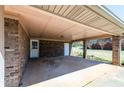 Spacious carport featuring brick columns and access to storage rooms with a beautiful exterior view at 6175 Marilla St, Douglasville, GA 30135