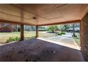Open carport area with brick columns, providing shelter and a view of the driveway and surrounding landscape at 6175 Marilla St, Douglasville, GA 30135
