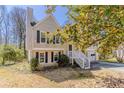 Traditional home featuring a two car garage, siding, and staircase to entry at 1270 Della Way, Lawrenceville, GA 30043