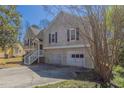 Traditional-style home showcasing a two car garage, siding, and staircase to entry at 1270 Della Way, Lawrenceville, GA 30043