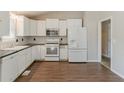 Bright kitchen featuring white cabinets, stainless steel appliances, and black countertops at 1270 Della Way, Lawrenceville, GA 30043