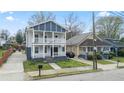 Attractive two-story home showcasing a dual porch, a long driveway, and proximity to neighboring houses at 992 Beckwith Sw St, Atlanta, GA 30314