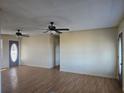 Bright living room with two ceiling fans and laminate flooring, creating a comfortable atmosphere at 1610 Mulberry Rock Rd, Dallas, GA 30157