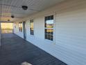 Inviting covered porch with a gray wood floor, offering a relaxing outdoor space and natural light at 1610 Mulberry Rock Rd, Dallas, GA 30157