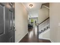 Inviting home entrance with hardwood floors, staircase, neutral walls, and dining area view at 207 Cross Rd, Acworth, GA 30102