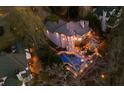 Aerial view of the home with a swimming pool and patio area at night at 1525 Lockridge Dr, Cumming, GA 30041