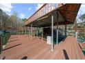 A boat dock with a covered area for boats and a wooden deck for fishing at 1525 Lockridge Dr, Cumming, GA 30041