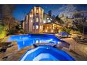 Backyard swimming pool and hot tub at night, lit with bright blue lights at 1525 Lockridge Dr, Cumming, GA 30041