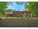 Spacious backyard featuring a brick house with a sunroom and a wooden deck perfect for entertaining at 2415 Bankstone Sw Dr, Marietta, GA 30064