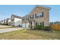 Inviting two-story brick home boasting a well-kept lawn and convenient two-car attached garage at 3464 Enterkin Ln, Atlanta, GA 30349