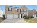 Attractive two-story brick home features a welcoming entrance and a two-car attached garage at 3464 Enterkin Ln, Atlanta, GA 30349