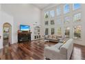 Spacious living room features hardwood floors, a fireplace, and a wall of windows for natural light at 4540 Hastings Dr, Cumming, GA 30041