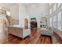 Spacious living room with hardwood floors, a fireplace, and an abundance of natural light at 4540 Hastings Dr, Cumming, GA 30041