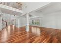 Bright living room with hardwood floors, wainscoting, and a soaring two-story ceiling at 4540 Hastings Dr, Cumming, GA 30041