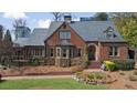 Beautiful brick home with manicured lawn, stone steps, and well maintained landscaping at 46 Montclair Ne Dr, Atlanta, GA 30309