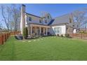 Stately home featuring a manicured lawn, fenced yard, and inviting front porch at 812 Newsome Nw Aly, Marietta, GA 30064