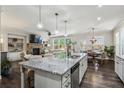 Open-concept kitchen with a large island, granite countertops, and stainless steel appliances at 187 Still Pine Bnd, Smyrna, GA 30082