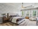 Serene main bedroom with tray ceilings, floral wallpaper, and an abundance of natural light at 187 Still Pine Bnd, Smyrna, GA 30082