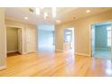 Open-concept living room with hardwood floors, neutral walls, and access to kitchen and bedrooms at 50 Biscayne Nw Dr # 6111, Atlanta, GA 30309