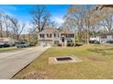 Attractive two-story home with a double garage, set on a spacious lot with a long driveway and mature trees at 8471 Duncan St, Douglasville, GA 30134