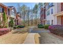 Well-maintained neighborhood featuring lush landscaping and sidewalks connecting attractive townhomes at 2382 Gallard St, Lawrenceville, GA 30043
