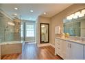 Spa-like bathroom with glass shower, double vanity, granite countertops, and modern fixtures at 3213 Arborwoods Dr, Johns Creek, GA 30022