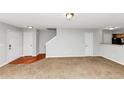 Open floor plan with carpet in living area with hardwood transition to kitchen at 735 Crestwell Sw Cir, Atlanta, GA 30331