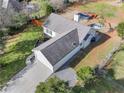 An aerial view of a well-maintained home with a long driveway and a beautiful green backyard at 7750 Silversmith Dr, Cumming, GA 30028