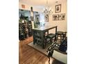 A dining area featuring a bar-height table with storage and eclectic artwork at 315 Saratoga Pl, Riverdale, GA 30296