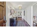 Bright foyer featuring hardwood floors, a crystal chandelier, and a decorative console table at 1299 W Wesley Nw Rd, Atlanta, GA 30327