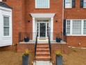 Welcoming front porch with elegant potted plants and decorative wrought iron railings at 1421 Briarcliff Dr, Woodstock, GA 30189