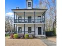 Inviting two-story home with a double porch, featuring classic architectural details at 1450 Donald Lee Hollowell Nw Pkwy, Atlanta, GA 30318