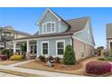 Charming home featuring blue siding and brick accents, complemented by lush landscaping in a welcoming setting at 200 Oakside Way, Lawrenceville, GA 30046