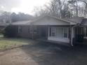 Traditional brick home featuring a covered entry and adjacent carport at 2076 Dobbins Nw Dr, Kennesaw, GA 30144