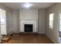 Cozy living room featuring a traditional fireplace and hardwood flooring at 2076 Dobbins Nw Dr, Kennesaw, GA 30144