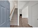 Bright foyer with hardwood floors, staircase, and access to the living spaces at 380 Waterbluff Dr, Mableton, GA 30126