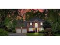 Charming two-story red brick home with an attached two-car garage set at sunset at 3951 Lorien Nw Way, Kennesaw, GA 30152
