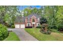 Beautiful two-story red brick home featuring a two-car garage and well-manicured front lawn at 3951 Lorien Nw Way, Kennesaw, GA 30152