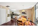 Open concept kitchen and dining area with hardwood floors and modern appliances, ideal for cooking and entertaining at 145 15Th Ne St # 204, Atlanta, GA 30309