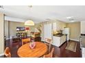 Inviting living space with hardwood floors, a cozy armchair, and a view of the staircase to the upper level at 145 15Th Ne St # 204, Atlanta, GA 30309