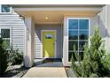Inviting front porch featuring a bright yellow door, a large window, and stylish architectural details at 1732 Red Maple Rdg, Atlanta, GA 30316