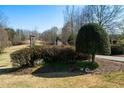 Welcoming property entrance with stone pillars, mature landscaping and clearly marked address for easy identification at 680 Milligan Creek Rd, Roopville, GA 30170