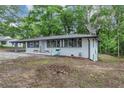 Beautiful one-story home with a white brick exterior, black trim windows, and cozy porch seating at 8065 Highway 92 Dallas, Douglasville, GA 30134