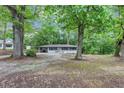 A cozy one-story home surrounded by mature trees, offering a peaceful and private setting at 8065 Highway 92 Dallas, Douglasville, GA 30134