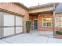 Welcoming entrance features a brick facade, attached garage, and charming front door decor at 120 Chastain Nw Rd # 1104, Kennesaw, GA 30144