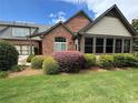 Charming home with a brick and siding exterior, well-maintained landscaping, and a manicured green lawn at 120 Chastain Nw Rd # 1104, Kennesaw, GA 30144